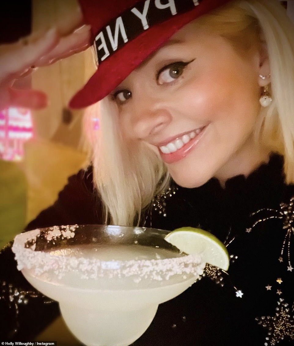 New Year! Holly Willoughby looks glamorous as she enjoys a margarita