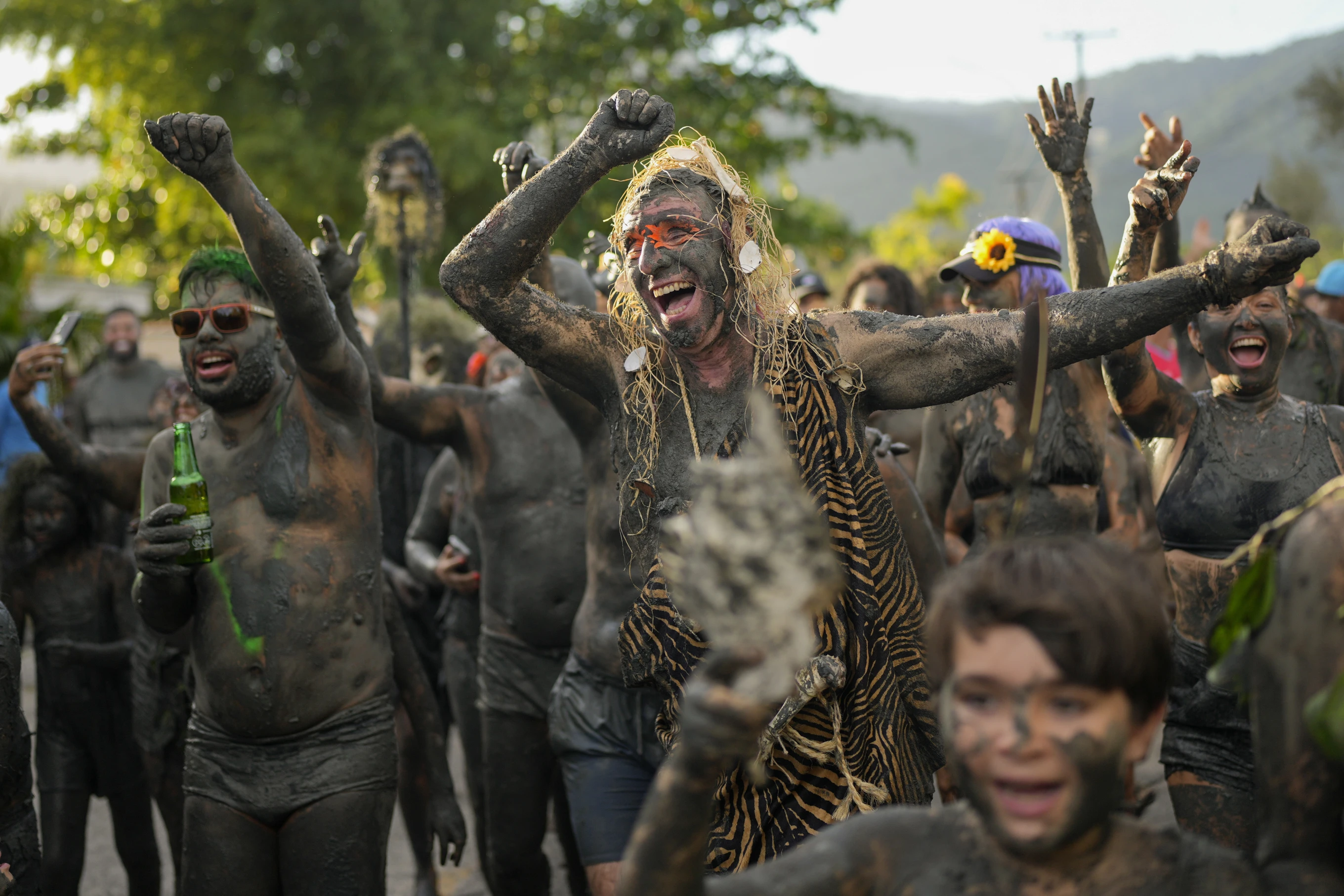 Mud-covered Carnival revelers are a strange sight in sleepy Brazilian town