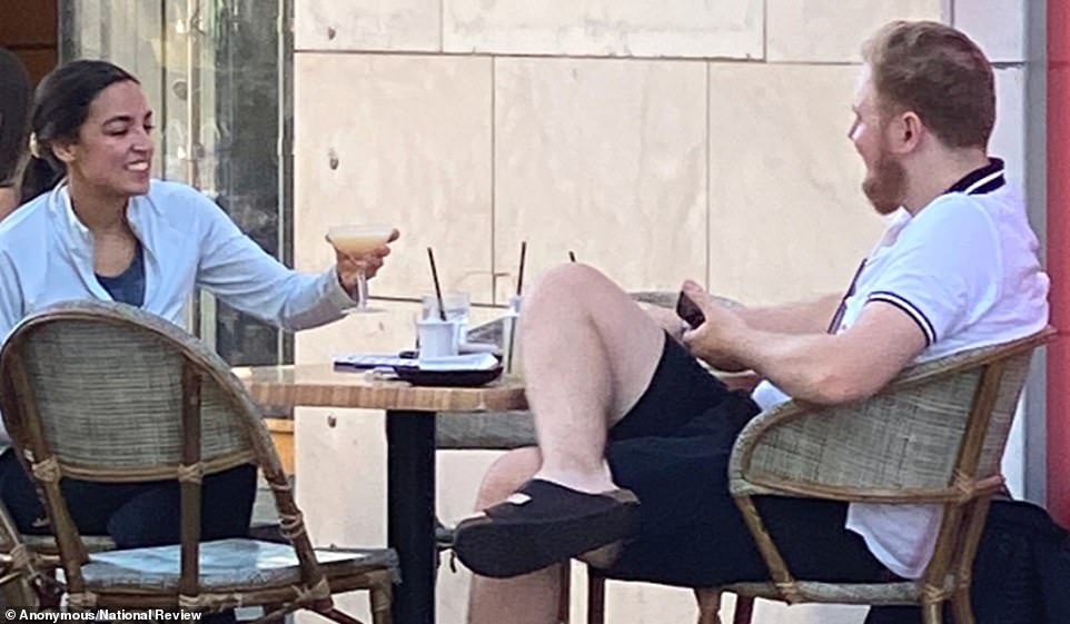 PICTURED: Maskless AOC raises a cocktail at dinner in Miami Beach