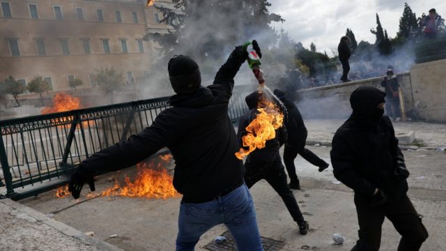 Protesters throw petrol bombs at police as Greece shuts down with flights grounded