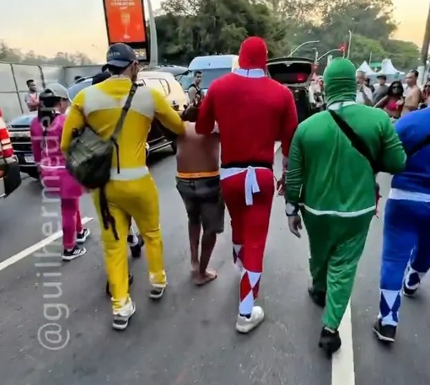 Bizarre moment cops dressed as Power Rangers arrest suspect at carnival as hunt for accomplice on the run...