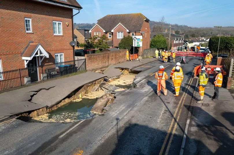 Giant sinkhole forces high street evacuation as tarmac crumbles around buildings