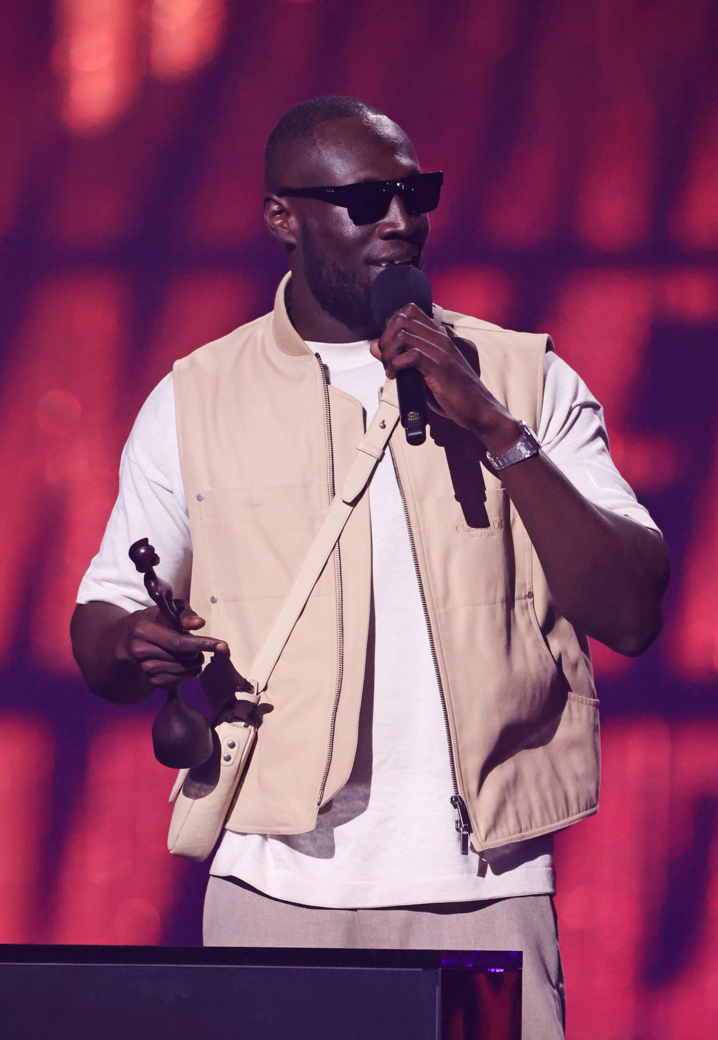 Stormzy struggles to read his notes as he’s forced to wear sunglasses on stage after painful injury...