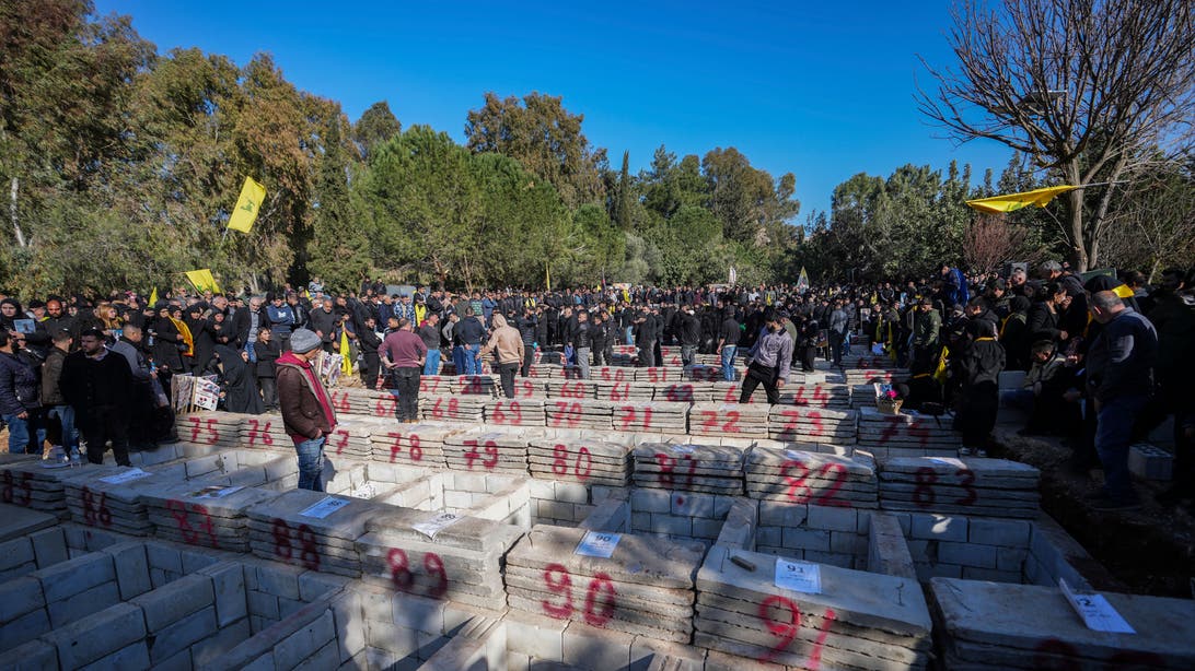 With flowers, tears and defiance, thousands bury nearly 100 Lebanese in mass funeral