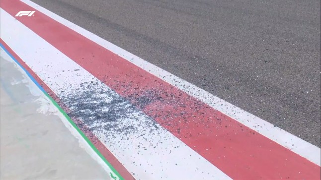 F1 pre-season testing suspended after a broken window falls on track