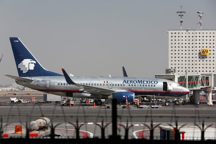 A man opened a plane's emergency exit and walked onto its wing after his flight was delayed on the tarmac for 4 hours. His fellow passengers are now defending him: 'He saved our lives'