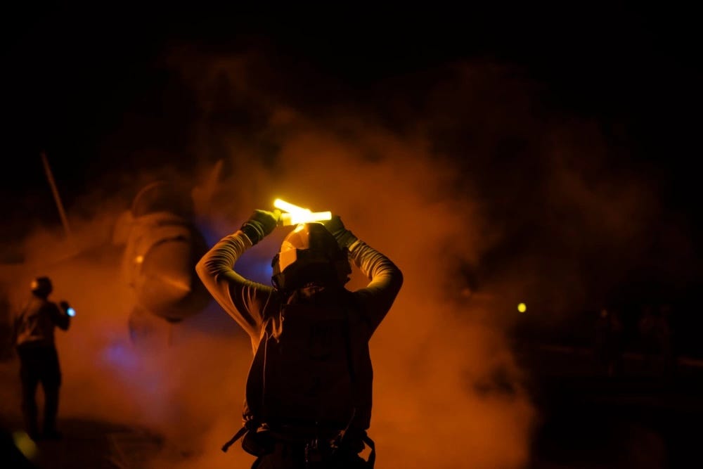 Photos show US carrier's nighttime missions to counter Houthi rebels