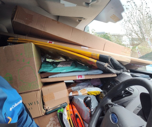 Delivery driver with mountains of boxes inside van caught red-handed