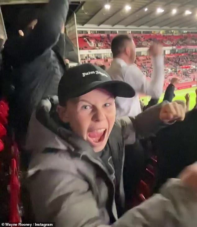 Kai Rooney watches his first away game with footballer dad Wayne