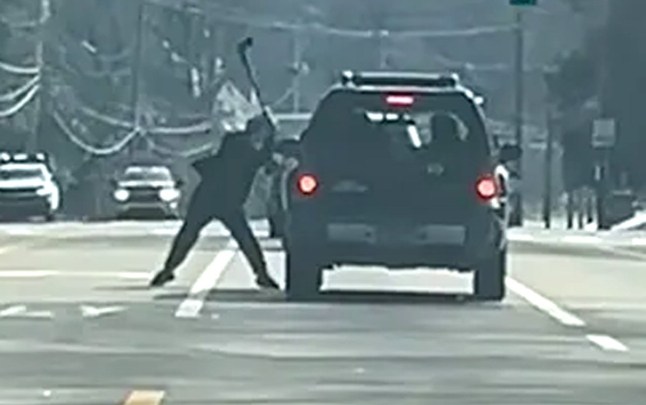 Man strikes couple's car with an axe in broad daylight