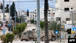 Israel ramps up West Bank offensive and says troops to remain in some areas 'for the coming year' 